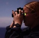 Ensign Ogent scans horizon during nighttime training on USS Barry