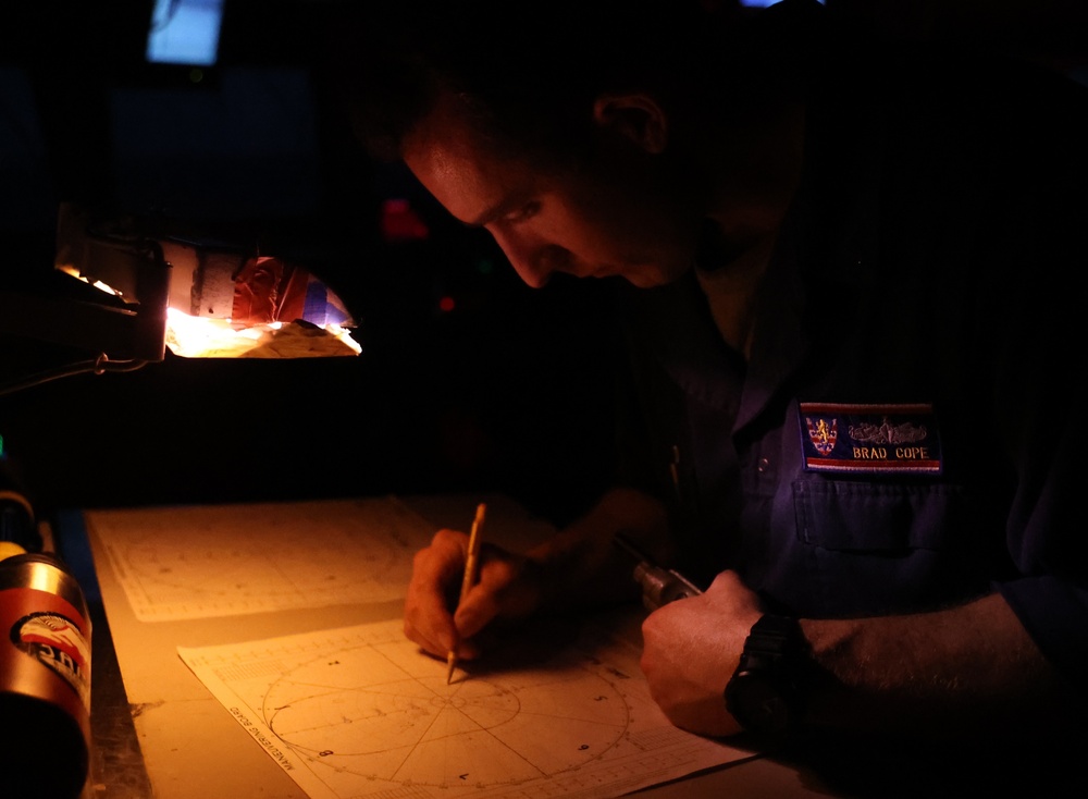Ensign Cope plots a contact aboard USS Barry