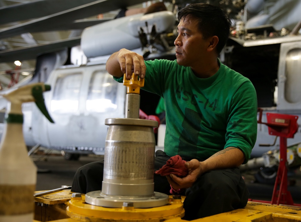 Abraham Lincoln Sailors conduct aircraft maintenance