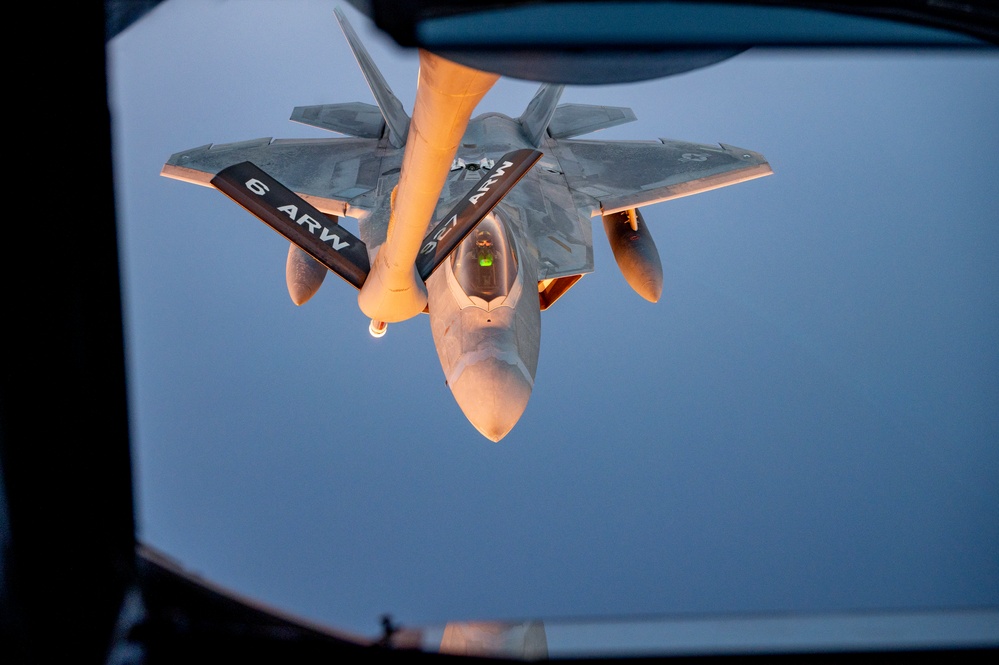 340th EARS refuels F-22s at sunset