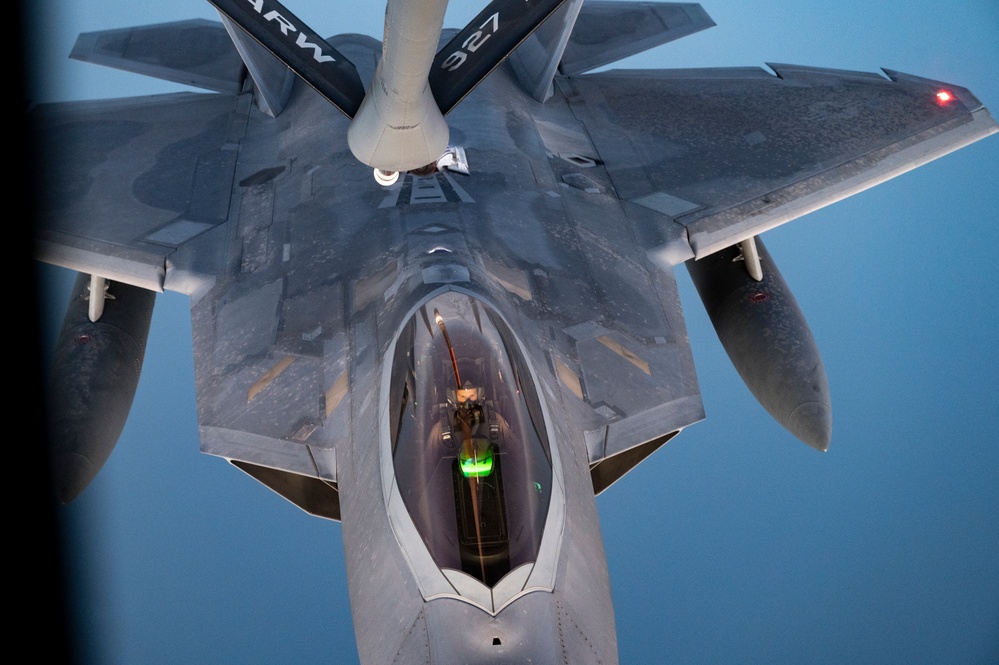 340th EARS refuels F-22s at sunset