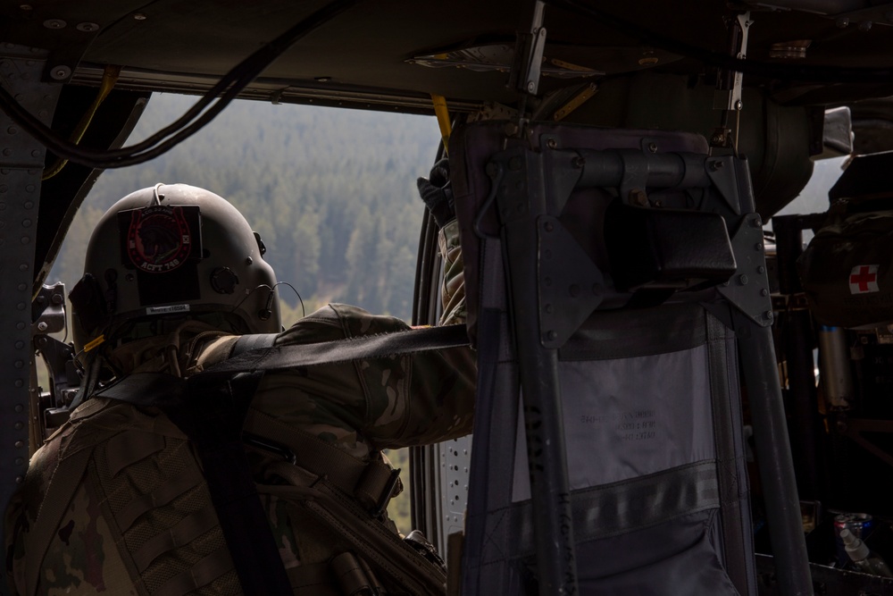 Sgt. Tyler White surveys the environment during the Blackhawk’s ascent at Grafenwoehr Training Area, Germany, March 16, 2022