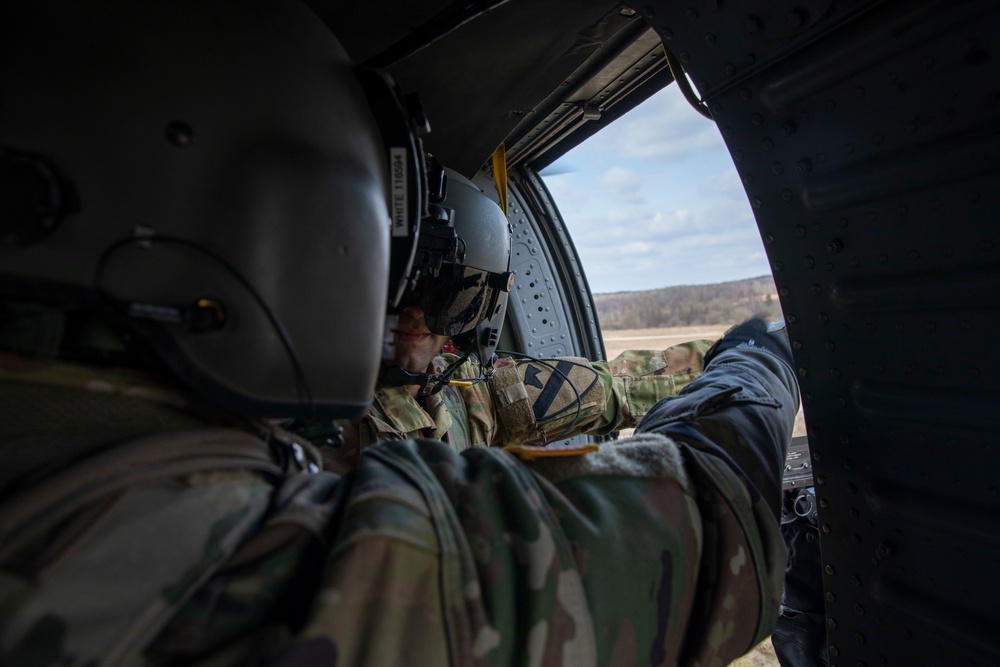 CW2 Christopher Butterfield listens to Sgt. Tyler White explain the parameters of their unit’s weapon’s qualification at Grafenwoehr Training Area, Germany on March 16, 2022