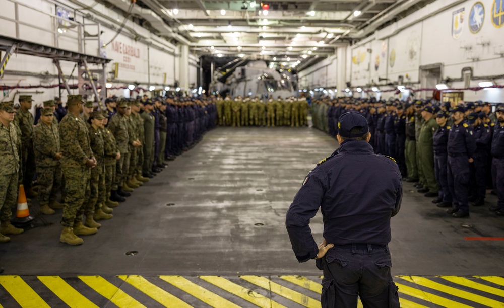 U.S. and Italian Service Members Hold All Hands Formation at Sea