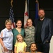 Tech. Sgt. McNamara (center right, in uniform) poses with family members after her most recent promotion ceremony.