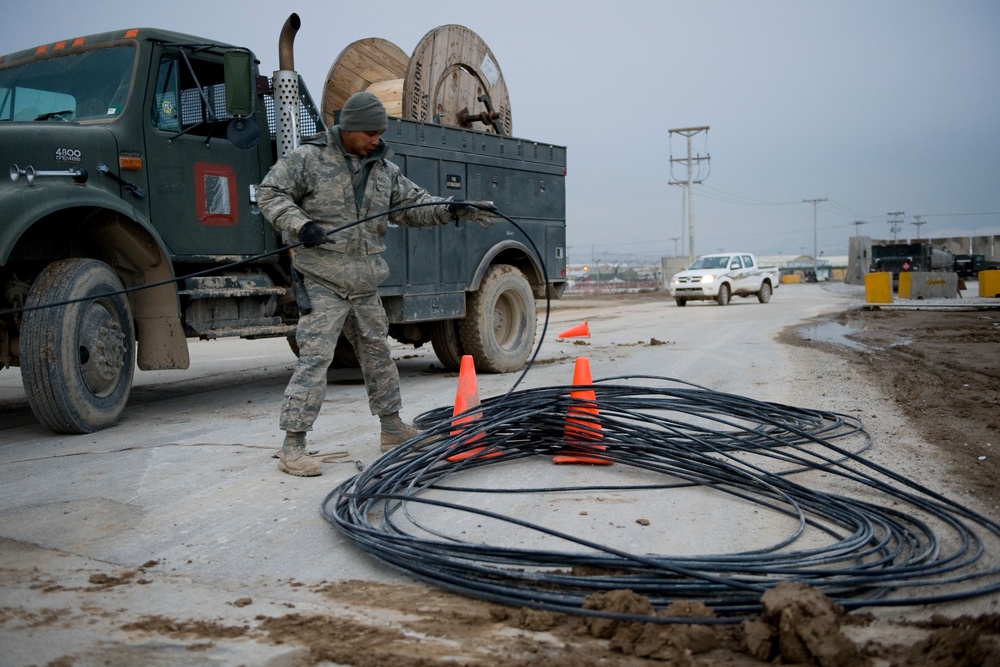 Personnel from the 212th Air National Guard, Milford, MA., 202nd Engineering and Installation Squadron (EIS), Macon, GA, 285th EIS, Biloxi, MS and the 215 EIS, Everett, WA. join forces at Bagram Airfield, Afghanistan to install fiber optic cable