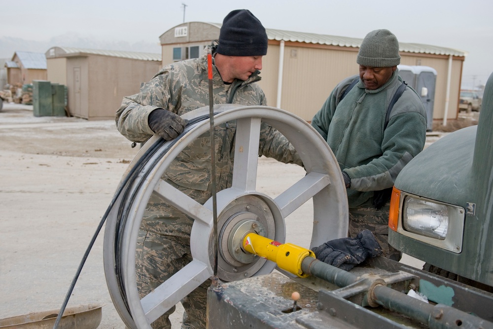 Personnel from the 212th Air National Guard, Milford, MA., 202nd Engineering and Installation Squadron (EIS), Macon, GA, 285th EIS, Biloxi, MS and the 215 EIS, Everett, WA. join forces at Bagram Airfield, Afghanistan to install fiber optic cable