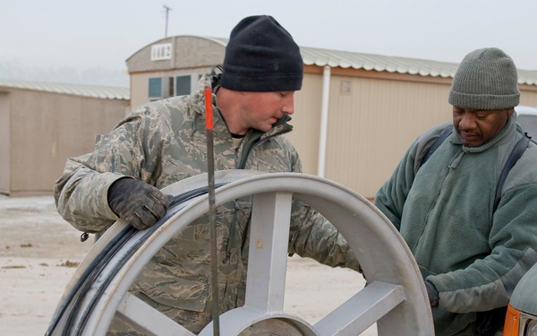 Personnel from the 212th Air National Guard, Milford, MA., 202nd Engineering and Installation Squadron (EIS), Macon, GA, 285th EIS, Biloxi, MS and the 215 EIS, Everett, WA. join forces at Bagram Airfield, Afghanistan to install fiber optic cable