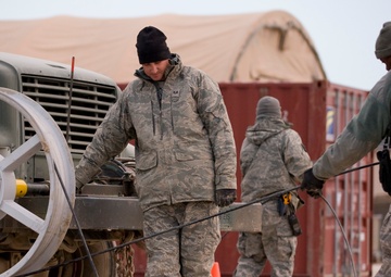 Personnel from the 212th Air National Guard, Milford, MA., 202nd Engineering and Installation Squadron (EIS), Macon, GA, 285th EIS, Biloxi, MS and the 215 EIS, Everett, WA. join forces at Bagram Airfield, Afghanistan to install fiber optic cable