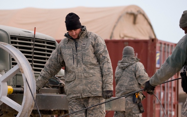 Personnel from the 212th Air National Guard, Milford, MA., 202nd Engineering and Installation Squadron (EIS), Macon, GA, 285th EIS, Biloxi, MS and the 215 EIS, Everett, WA. join forces at Bagram Airfield, Afghanistan to install fiber optic cable