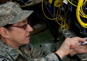 MSgt Lyn Fry prepares an equipment rack for fiber optic cable installation at Bagram Air Field in Afghanistan