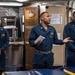 Senior Chief Culinary Specialist Carlos Richardson, middle, from Birmingham, Ala., conducts a liberty brief with Sailors