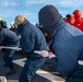 Sailors aboard Arleigh Burke-class guided-missile destroyer USS Mitscher (DDG 57) practice line handling while entering port in Aksaz, Turkey