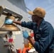 A Sailor Conducts Maintenance Aboard USS Ralph Johnson (DDG 114)