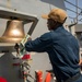 A Sailor Conducts Maintenance Aboard USS Ralph Johnson (DDG 114)