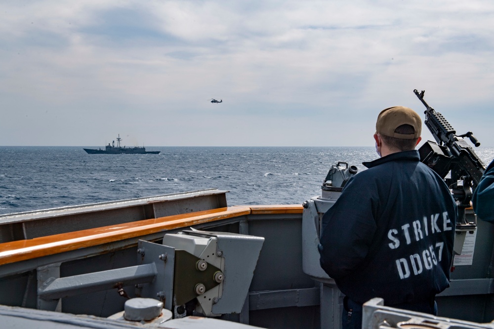 Ensign Jameson Brown-Padien, from Block Island, R.I., aboard USS Mitscher (DDG 57) watches as Turkish Navy Oliver Hazard Perry-class frigate TCG Giresun (F 491) conducts flight operations