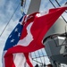 Quartermaster 2nd Class Dylan Stevens, top, from Irvine, Ky., and Quartermaster Seaman Gonzalo Pinedafausto, bottom, from Los Angeles, Calif., haul up the battle ensign