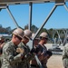 US Navy Seabees with Naval Mobile Construction Battalion 5 build a Mabey Johnson Bridge