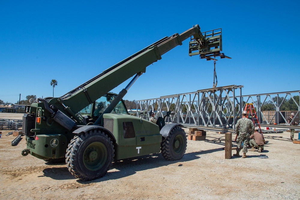 US Navy Seabees with Naval Mobile Construction Battalion 5 build a Mabey Johnson Bridge