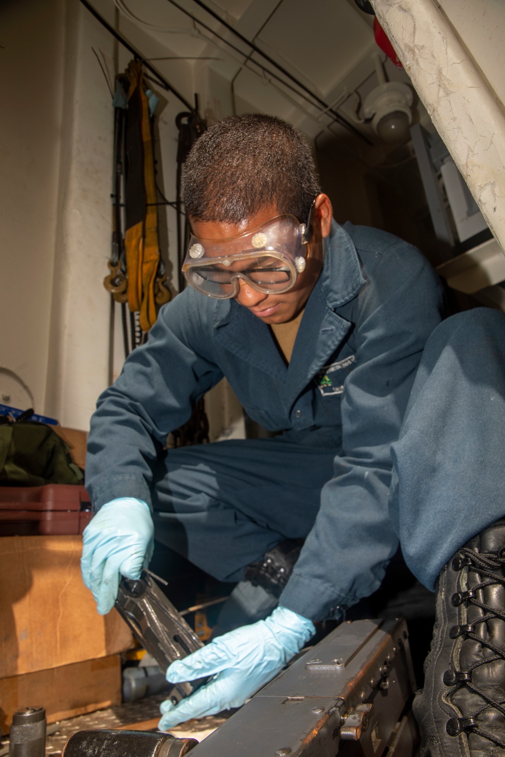 A Sailor Cleans an M2HB 50 Caliber Machine Gun Aboard USS Ralph Johnson (DDG 114)