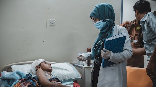 USAID-Trained Physician Speaks with Patient at Hospital in Yemen