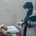 USAID-Trained Physician Speaks with Patient at Hospital in Yemen