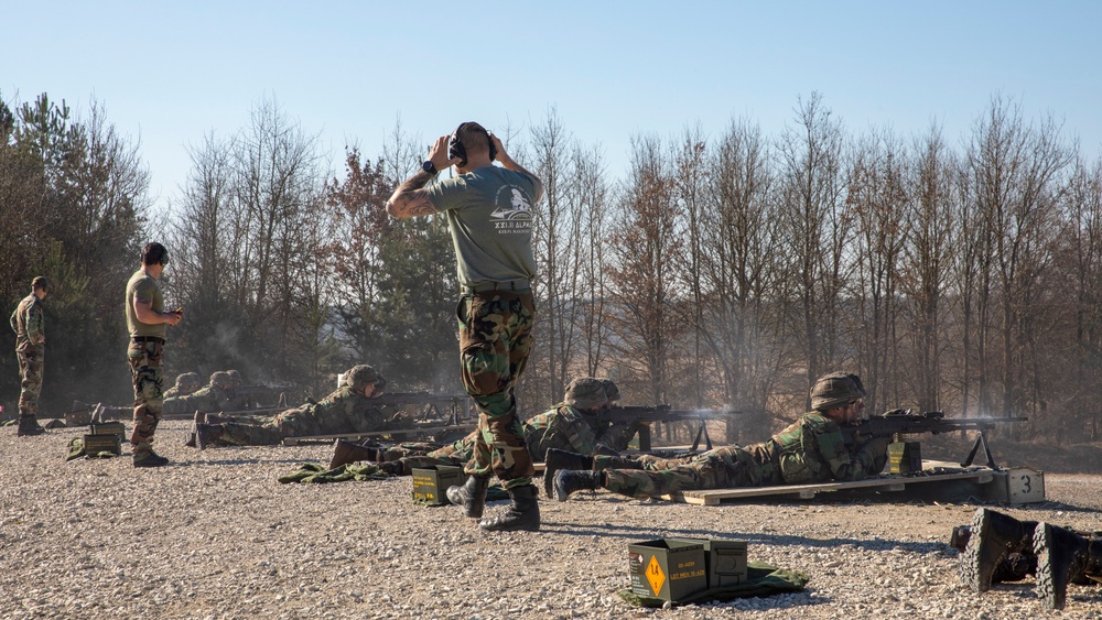 Instructors observe a line of Dutch Marines fire at the range