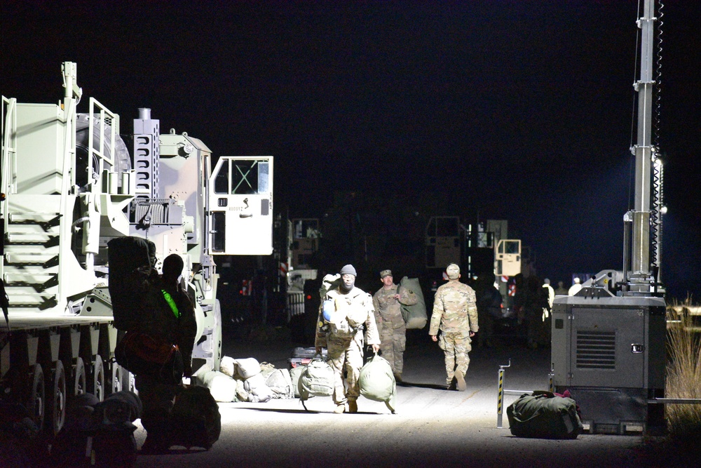 Soldiers take gear to trucks