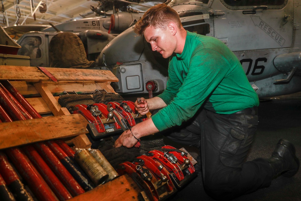 Abraham Lincoln Sailors conduct aircraft maintenance