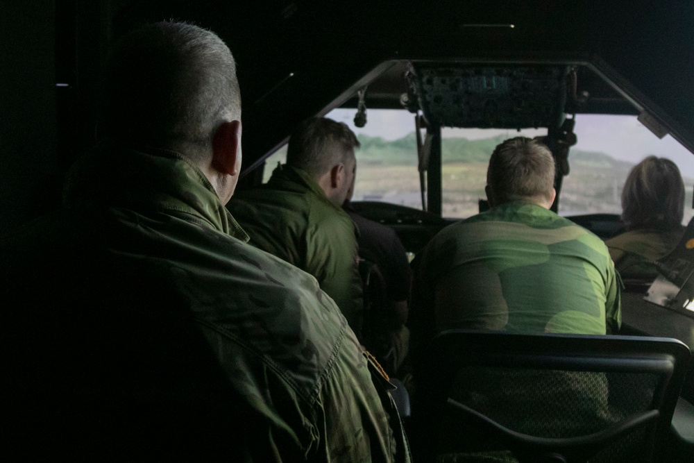 Norwegian leaders simulated flying a UH-60 Black Hawk helicopter at Camp Ripley