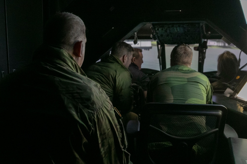Norwegian leaders simulated flying a UH-60 Black Hawk helicopter at Camp Ripley