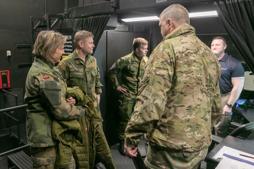 Norwegian leaders simulated flying a UH-60 Black Hawk helicopter at Camp Ripley