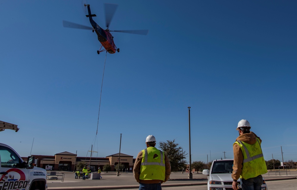 A helicopter from 5 State Helicopter Inc. replaces the heating, ventilation and air conditioner units.