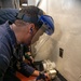 Gas Turbine Systems Technician (Mechanical) 1st Class Andrew Chin, from Mt. Vernon, N.Y., chisels the deck to adhere a non-skid mat