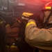 Sailors conduct overhaul of a simulated fire with a rake and Naval Firefighter Thermal Imager during a firefighting drill