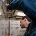 Ensign James Tully, from Long Island, N.Y., marks reported notes on a ship diagram during a firefighting drill