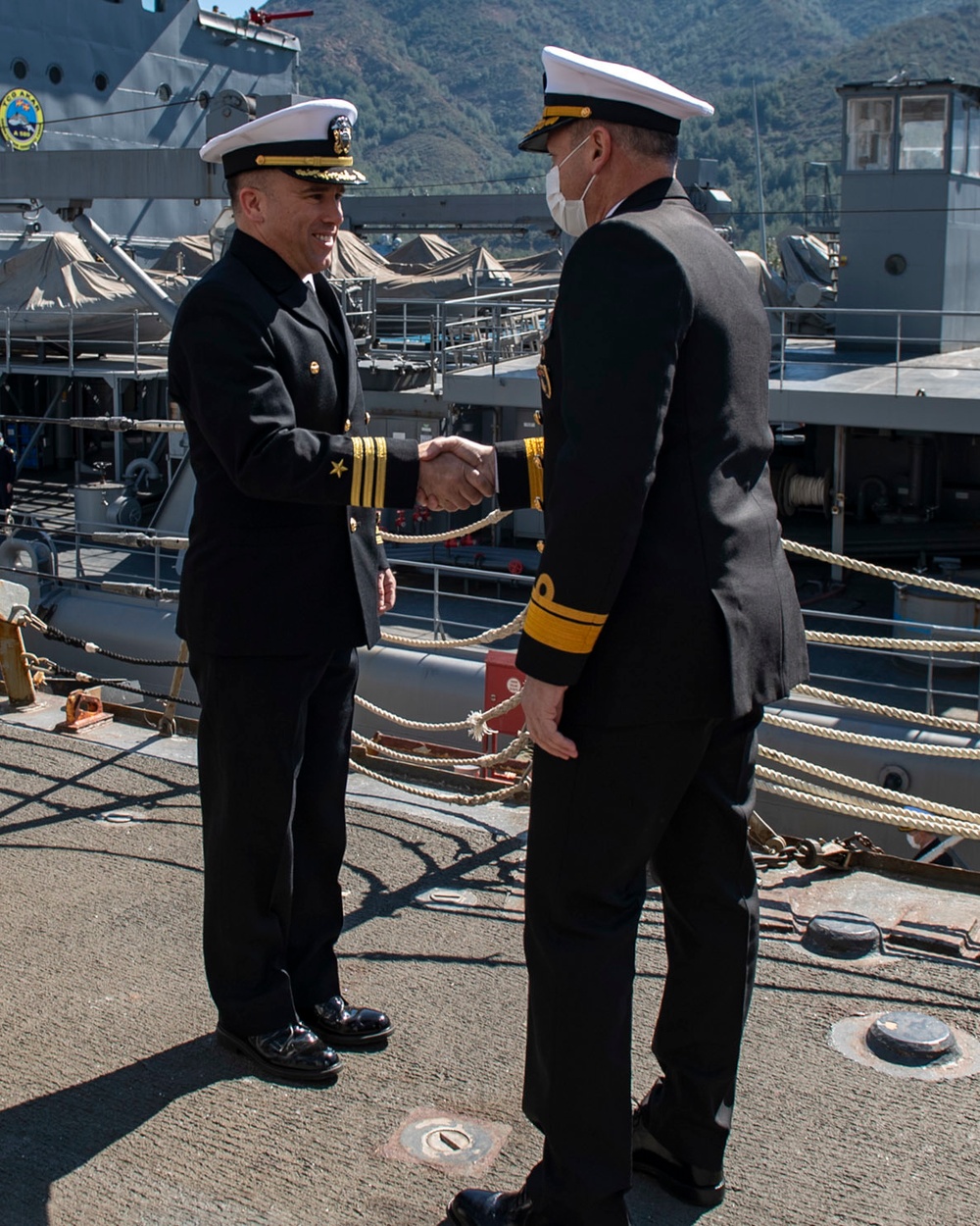 Cmdr. Thomas McCandless, commanding officer, Arleigh Burke-class guided-missile destroyer USS Mitscher (DDG 57) greets Rear Adm. Mehmet Emre Sezenler, Turkish Navy, commander, South Task Group Command, during a ship tour