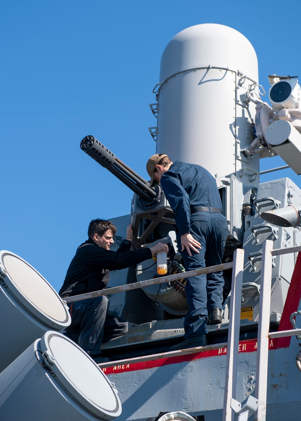 Fire Controlman 1st Class Anthony Wilkes, left, from Petersburg, Ind., and Fire Controlman 2nd Class Nathan Gurle, right, from Auburn, Ill., conduct maintenance on a Mk 15 close-in weapons system