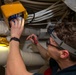 Electronics Technician 2nd Class John Flowers, from Lugoff, S.C., conducts maintenance on a battle lantern