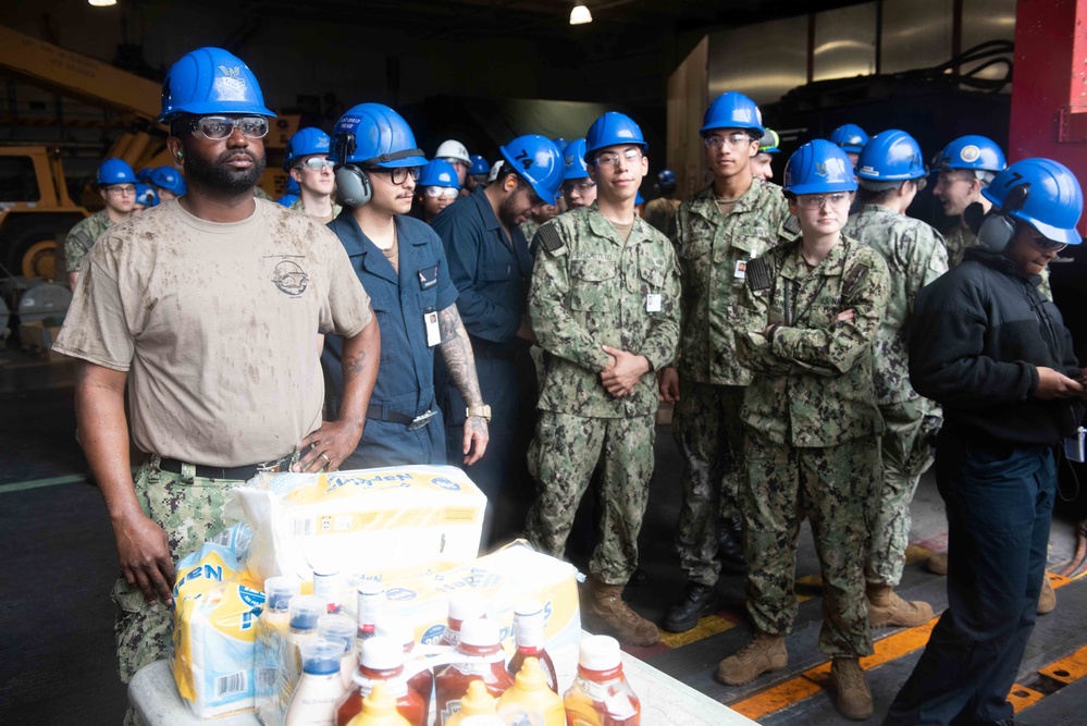 U.S. Navy Sailors, assigned to the aircraft carrier USS John C. Stennis (CVN 74), participate in a burger burn event, sponsored by the ship’s Mustang Association aboard the ship.