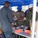 Members of the USS John C. Stennis Mustang Association serve meals to Sailors and Newport News Shipbuilding contractors in a burger burn event aboard the ship.