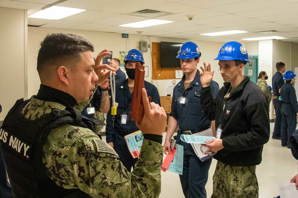 Master-At-Arms 3rd Class Joseph Reyes-Cede, from San Juan, Puerto Rico, assigned to the aircraft carrier USS John C. Stennis (CVN 74), gives gun safety training during a safety stand down.