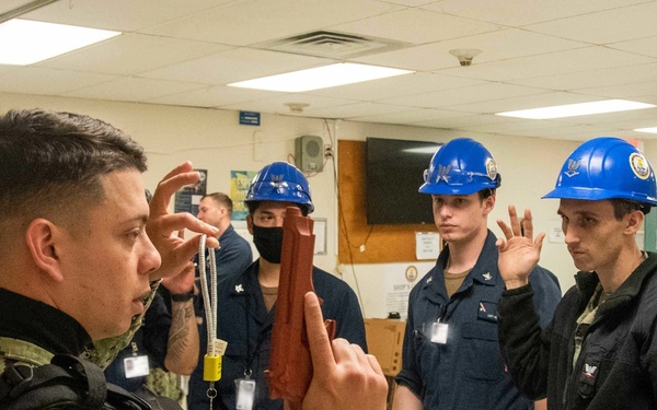 Master-At-Arms 3rd Class Joseph Reyes-Cede, from San Juan, Puerto Rico, assigned to the aircraft carrier USS John C. Stennis (CVN 74), gives gun safety training during a safety stand down.