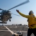 Boatswain’s Mate 3rd Class Tra’shaun Cooper, from Homestead, Texas, directs an MH-60S Sea Hawk helicopter assigned to the “Dragonslayers” of Helicopter Sea Combat Squadron (HSC) 11) to land