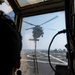 Lt. Joshua Primiano, from Weymouth, Mass., communicates with an MH-60S Sea Hawk helicopter assigned to the “Dragonslayers” of Helicopter Sea Combat Squadron (HSC) 11) in the flight tower