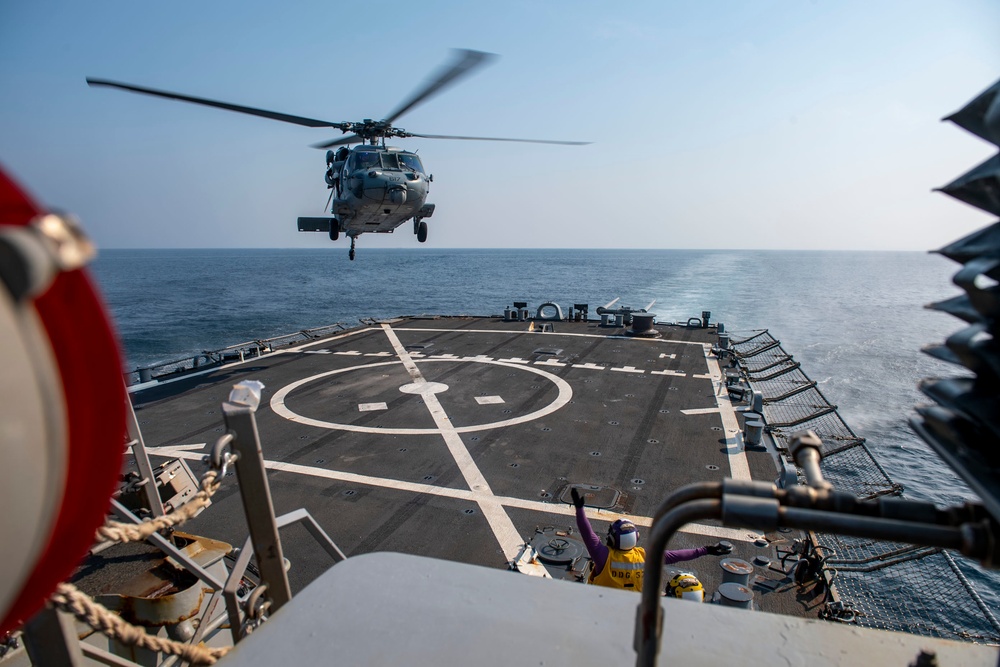 An MH-60S Sea Hawk helicopter assigned to the “Dragonslayers” of Helicopter Sea Combat Squadron (HSC) 11) prepares to land