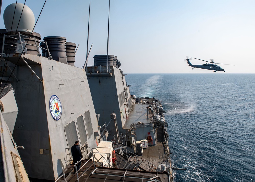 An MH-60S Sea Hawk helicopter assigned to the “Dragonslayers” of Helicopter Sea Combat Squadron (HSC) 11) departs the flight deck