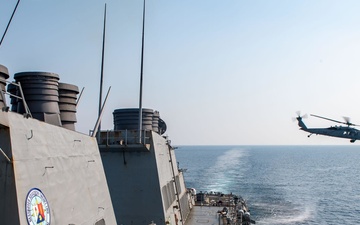 An MH-60S Sea Hawk helicopter assigned to the “Dragonslayers” of Helicopter Sea Combat Squadron (HSC) 11) departs the flight deck