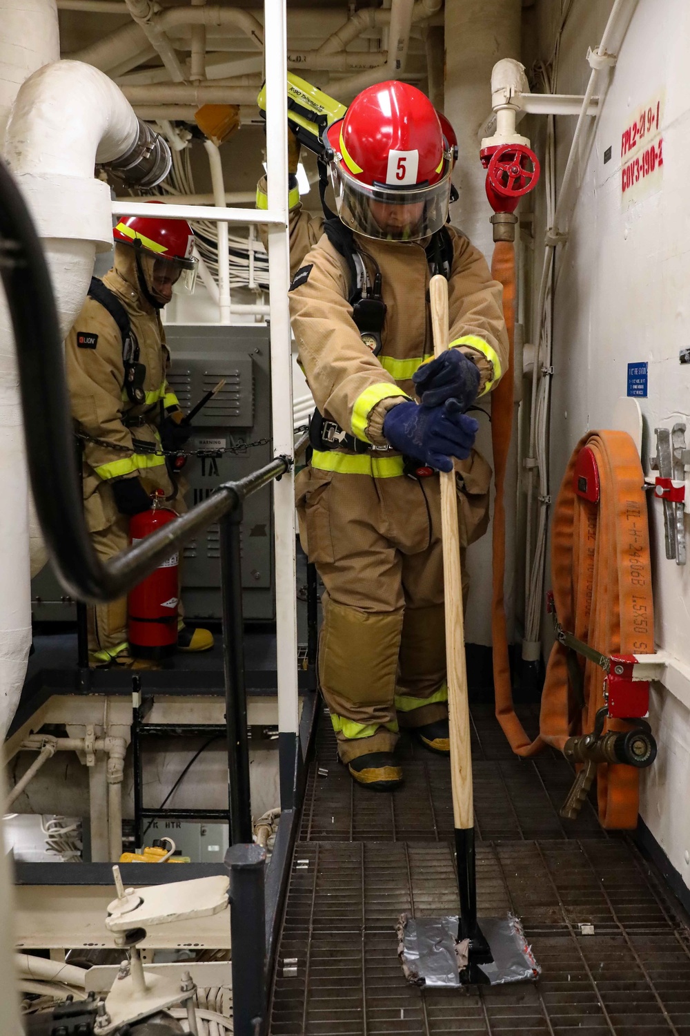 USS Ross Sailors hold main space fire drill