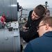 Gunner’s Mate 3rd Class Logan Marrocco, top, from Deer Park, Wash., instructs Sonar Technician (Surface) 3rd Class Joseph Brown, bottom, from Providence, R.I., on Mark-32 surface vessel torpedo tube maintenance